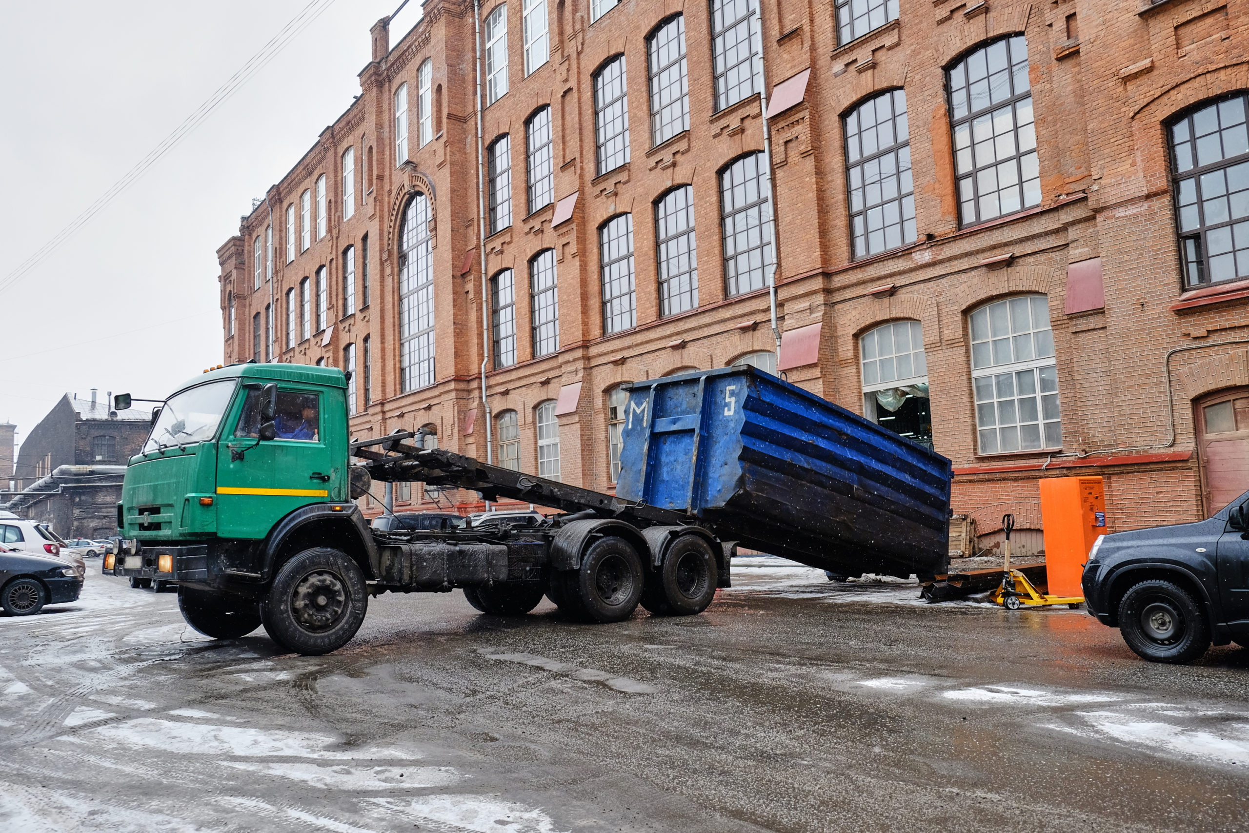 Commercial Dumpster Being Offloaded Onto a Street