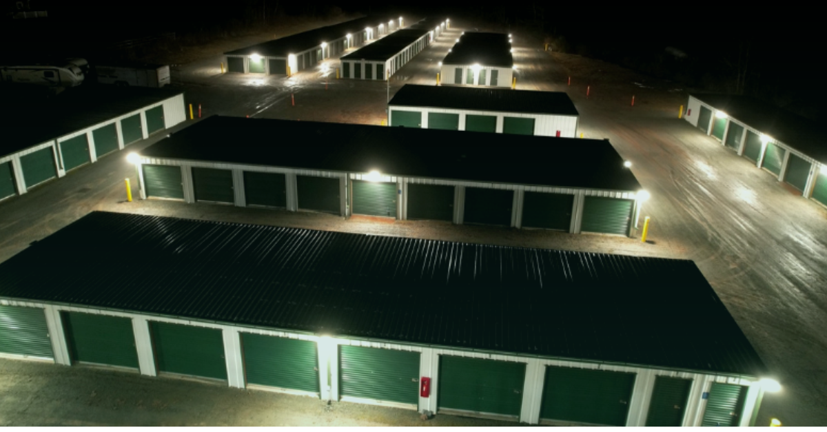 erial view of storage units at night with green illumination representing nighttime asset security monitoring