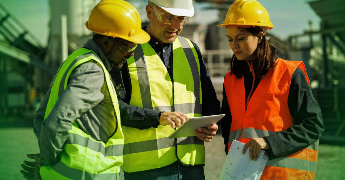 team reviewing asset data on tablet with GPS tracking visibility on site